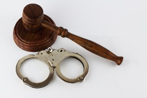 A gavel and handcuffs, representing a Defense Attorney in Pekin IL
