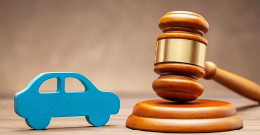 A gavel next to a wooden car toy, representing Traffic Violations in Peoria IL