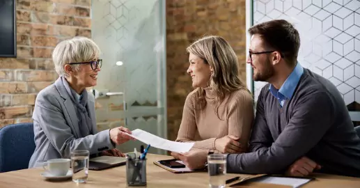 A lawyer discussing probate law with a couple helping manage the state of a recently deceased loved one