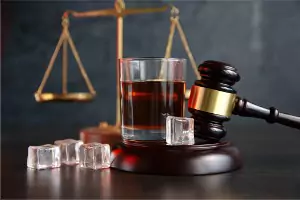 A gavel and a drink are seen. The Brave Law Center P.C. is a DUI Attorney in Pekin IL.