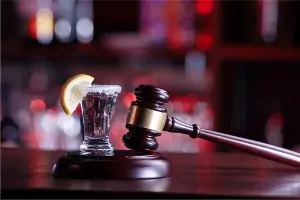 A gavel and drink are seen. Brave Law Center P.C. is a DUI Attorney in Peoria IL.